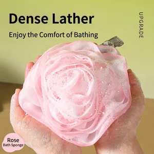 Pink rose shaped bath sponge net showing dense lather and foam for exfoliation
