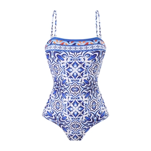 Detail of blue and white Mediterranean pattern on one-piece swimsuit with orange trim