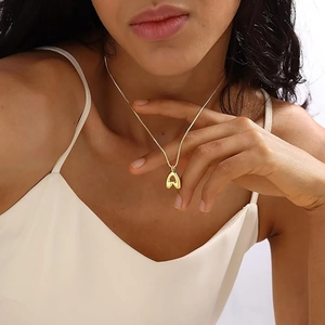 Minimalist gold-plated A-letter pendant necklace on model with polished finish style