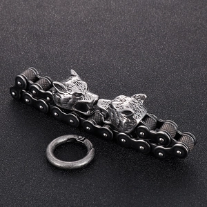 Vintage steel wolf head bike chain bracelet with distressed silver finish on black sand