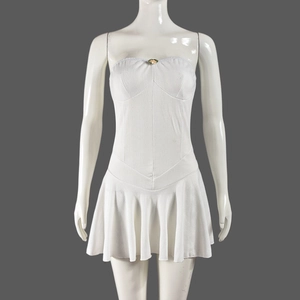 Detailed view of the white tube dress with ruffles on a model form