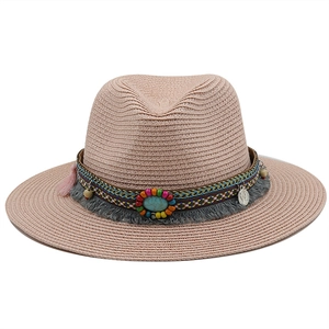 Detail of pink straw fedora with bohemian rope, turquoise stone, and silk tassels