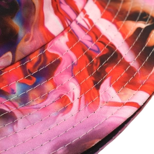 Macro detail of multi-row stitching on colorful tie-dye graffiti bucket hat fabric