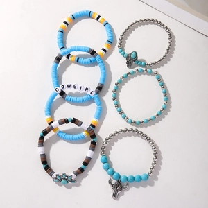 Detail of 7-piece bohemian turquoise cowgirl stretch bracelets with bull pendants