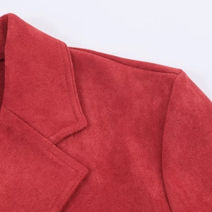 Detail of red faux suede jacket featuring precision stitching and notched lapel texture