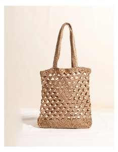 Detail view of the beige hollow mesh weave texture on this stylish straw tote beach bag
