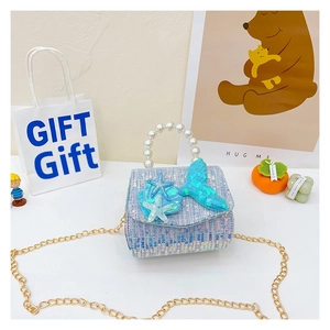 Detail of blue sequin tweed kids bag with pearl handle and mermaid tail decoration