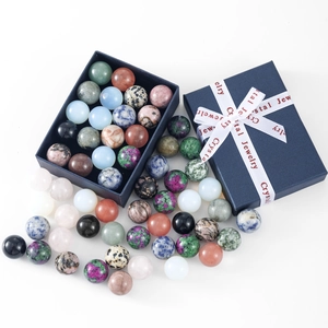 Macro detail of colorful natural crystal spheres in a blue gift box with silk ribbon