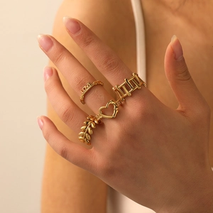 Four-piece gold titanium steel ring set featuring LOVE engraving and heart leaf patterns