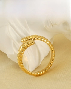 Detail of gold stainless steel ring with spiral texture and 18k plating finish
