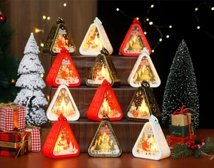 Close-up of LED Christmas lanterns with festive Santa and snowman graphics for holiday decor