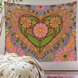 Bohemian floral heart tapestry hanging on a bedroom wall in a cozy setting