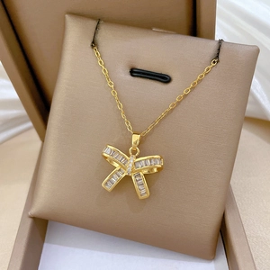 Macro detail of gold butterfly pendant with sparkling zircon crystals in a luxury gift box