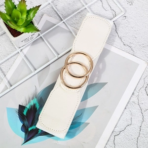 Detail shot of a white wide elastic waist belt with double golden ring buckle closure