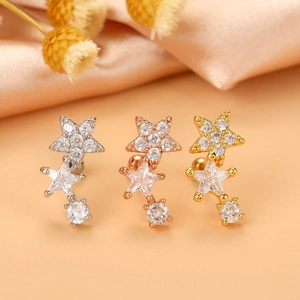 Detailed view of star-shaped zircon helix earrings in silver, rose gold, and gold finishes