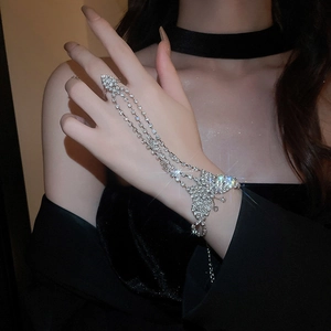 Detailed close-up of butterfly hand harness with sparkling crystals and silver finish