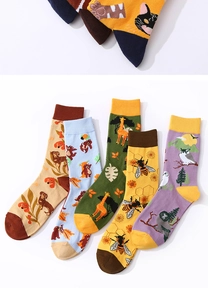 Detail view of five pairs of cotton mid-calf socks with various animal patterns and colors