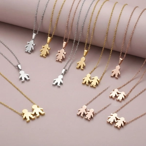 Detailed display of boy and girl pendants in gold, silver and rose gold stainless steel