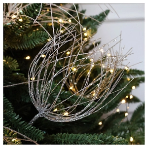 Close-up of silver glitter Christmas tree pick ornaments with radiant spray design