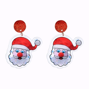 Close-up of Santa Claus PVC earrings with glittery red hats and colorful sequins