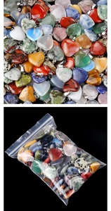 Macro shot of assorted heart-shaped natural stone pendants and bulk packaging display