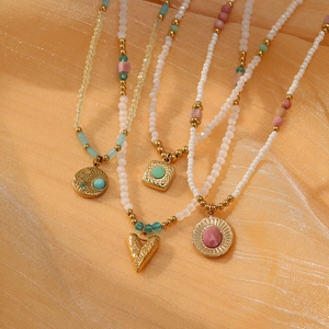 Sunflower rhodochrosite beaded necklace set with gold pendants on orange silk background