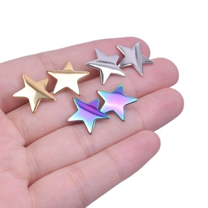 Detail view of star-shaped stainless steel earrings in gold, silver, and rainbow plating