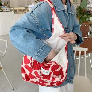Close-up of corduroy tote bag featuring red heart prints and inner storage pocket