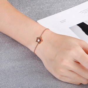 Adjustable rose gold star bracelet with crystal zircon inlay on sparkling background