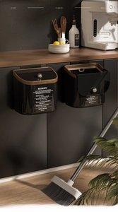 Modern wall-mounted kitchen waste bin set in matte black with elegant wood grain trim