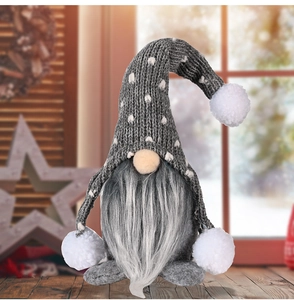Macro detail of Christmas gnome showing grey knit hat texture and white plush pompoms
