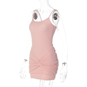 Close-up of pink rib-knit dress featuring sexy waist twist and ruched hip details