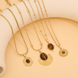 Gold stainless steel necklaces with brown tiger eye pendants in various geometric shapes