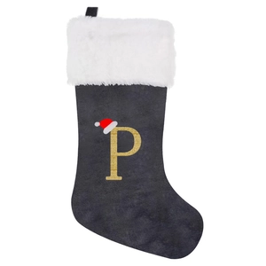 Detailed view of grey velvet Christmas stocking with white fur trim and golden letter P
