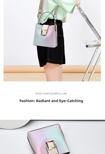 Detail of gradient bucket bag featuring a square gold buckle and wide fabric strap