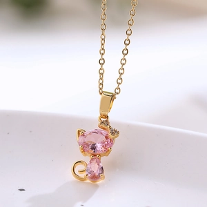 Gold titanium steel necklace featuring a cat pendant with pink crystals and bow detail