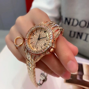 Close-up of luxury rose gold women's quartz watch with full crystal pavé on dial and bezel