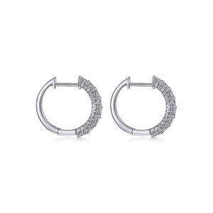 Silver hoop earrings with baguette and round cut stones on a white background