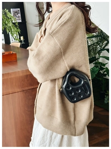 Fashionable black PVC jelly bag in retro telephone shape with gold chain strap detail