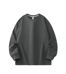 Macro detail of charcoal grey waffle knit texture on loose fit crewneck sweatshirt