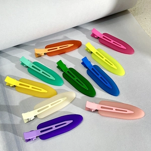 Flat lay of colorful matte duckbill hair clips set in ten vibrant pastel colors
