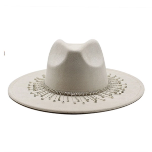 Detail of the sparkling rhinestone fringe trim on a beige wide brim suede bridal fedora hat