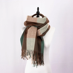 Detailed close-up of British style plaid scarf featuring brown and beige tassels