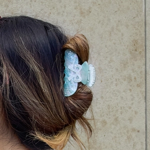 Elegant blue marble acetate hair claw with white rhinestone bow on hair