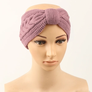 Detail of mauve cable knit headband with a twist knot on a mannequin model