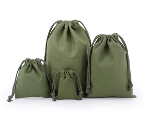 Detail view of four army green cotton drawstring pouches in various sizes on white background