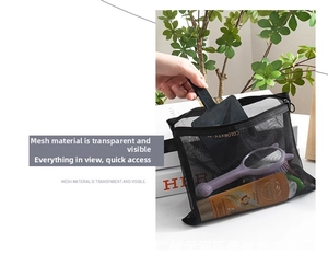 Detailed view of black mesh makeup bag filled with toiletries for travel organization