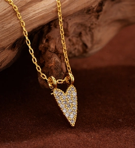 Macro detail of gold-plated S925 silver heart necklace with micro-paved zircons