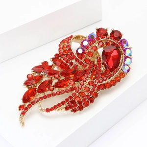 Elegant gold-tone feather brooch with vibrant red rhinestones and a large teardrop crystal