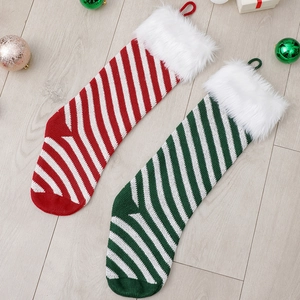 Striped knit Christmas stockings with faux fur trim in red and green for holiday gifts